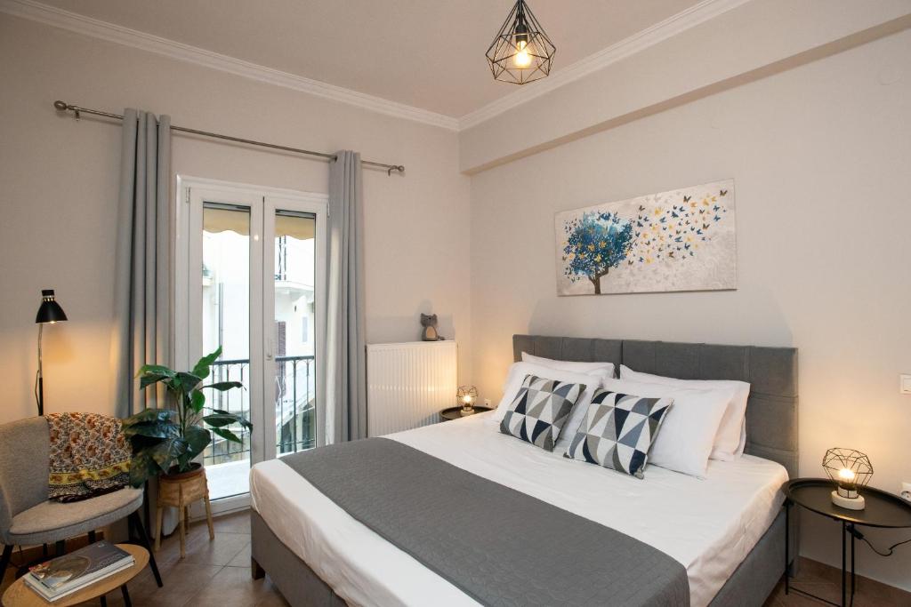 a bedroom with a large bed and a window at Filarmonia Suite Annunziata Corfu in Corfu