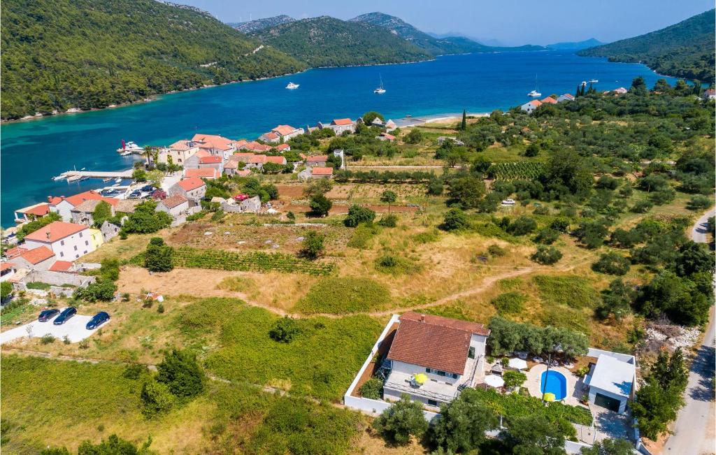 an aerial view of a house on a hill next to the water at Nice Home In Broce With House A Panoramic View in Broce