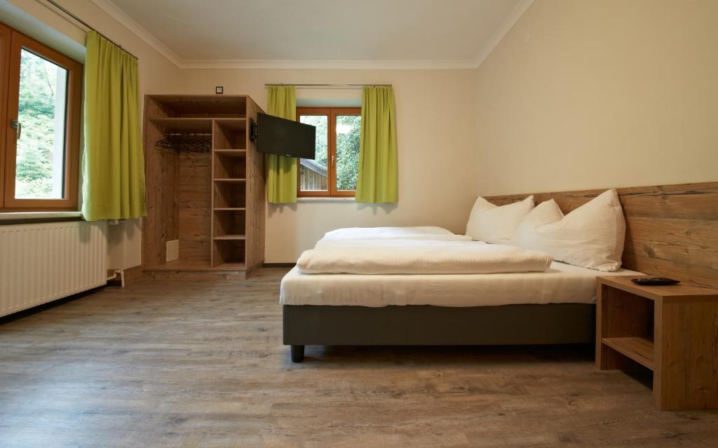 a bedroom with a large bed with yellow curtains at Holiday Lodge Central in Saalbach-Hinterglemm