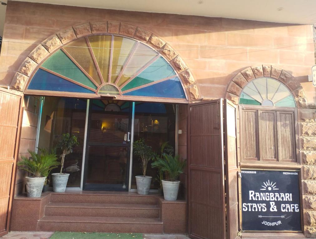 an entrance to a restaurant with potted plants in front at RANGBAARI STAYS & CAFE in Jodhpur