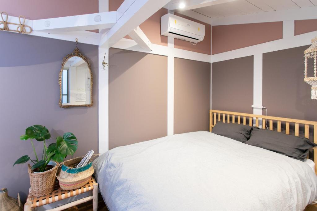 a bedroom with a white bed and a mirror at Bonjour Maison -Self check-in in Fukuoka