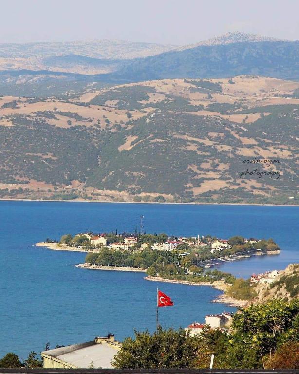 a red flag in the middle of a body of water at Choo Choo Pansiyon in Egirdir