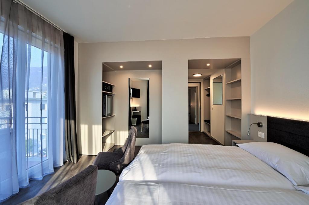 Postel nebo postele na pokoji v ubytování Hotel Luna Garni
