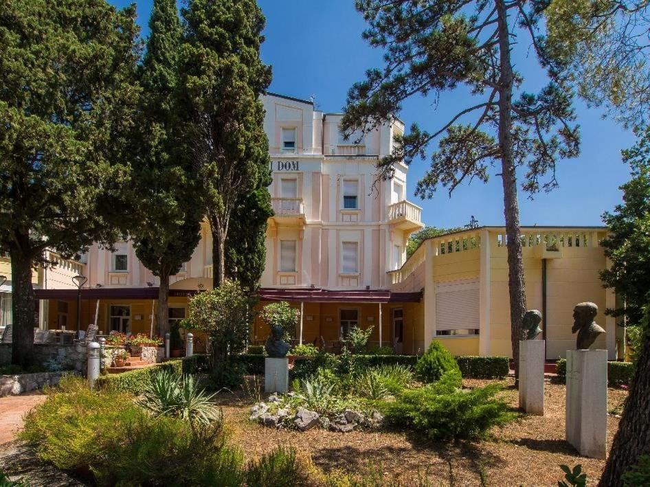 a large white building with trees in front of it at Hotel Vila Ružica- glavna zgrada i depandanse in Crikvenica