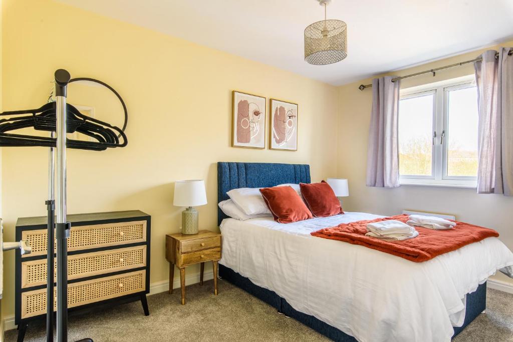 a bedroom with a bed and a window at Charming & Spacious 3BR With Private Parking Near Ipswich in Ipswich