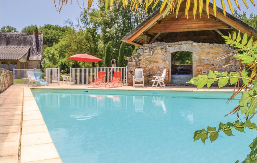a swimming pool with chairs and a pavilion at Cozy Home In Padiracbascoul With Wifi in Padirac