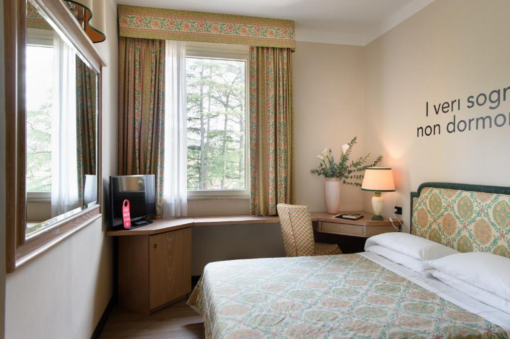 Postel nebo postele na pokoji v ubytování Grand Hotel Panoramic