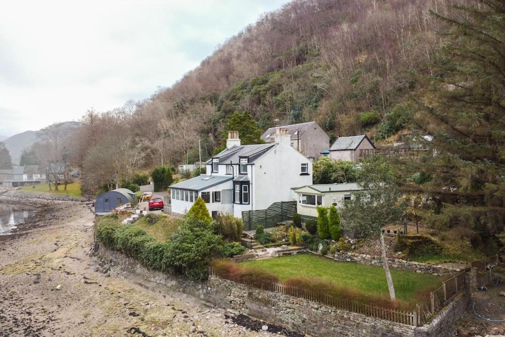 an aerial view of a house next to a river at Rossmay House - 4 Bedroom Scottish Villa with waterfront / mountain views in Arrochar
