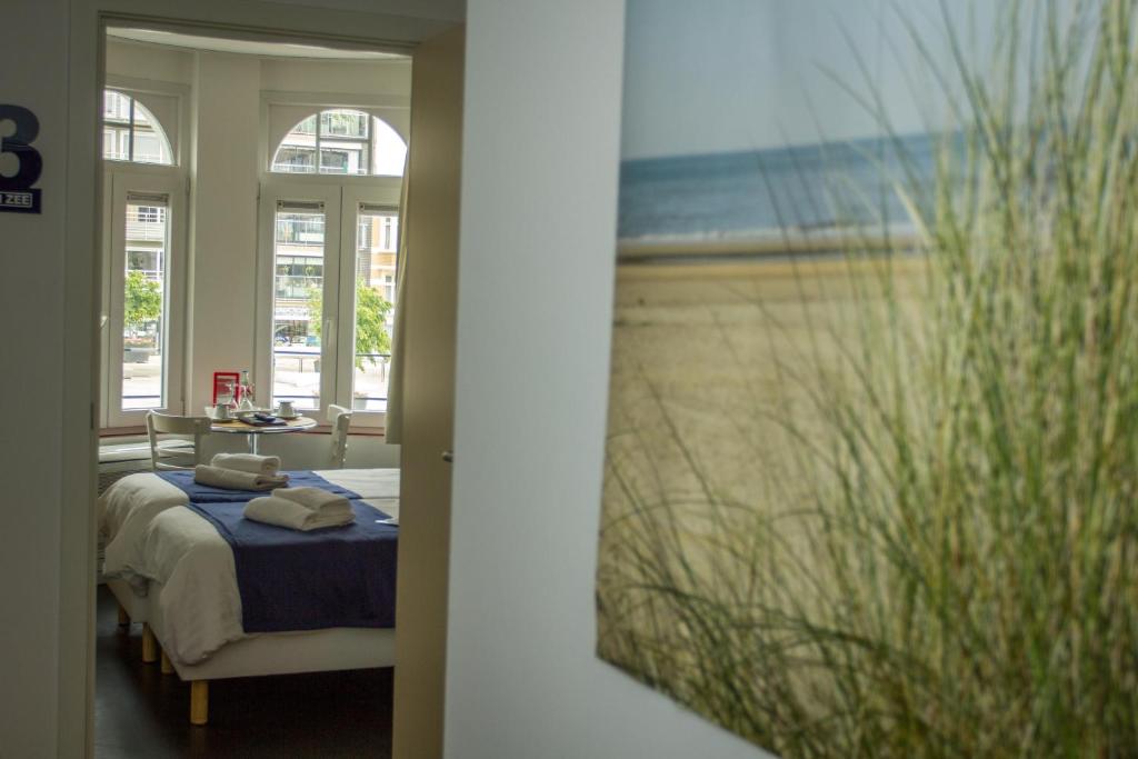 Postel nebo postele na pokoji v ubytování Hotel Aan Zee