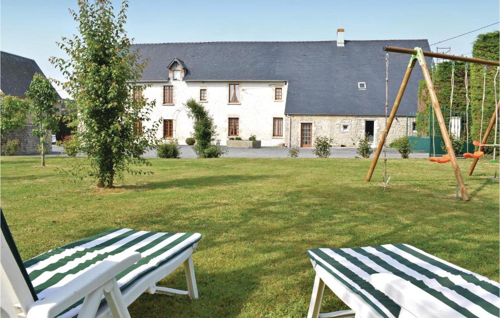 a white bench in a yard with a house at Nice Home In Canchy With Kitchen in Canchy