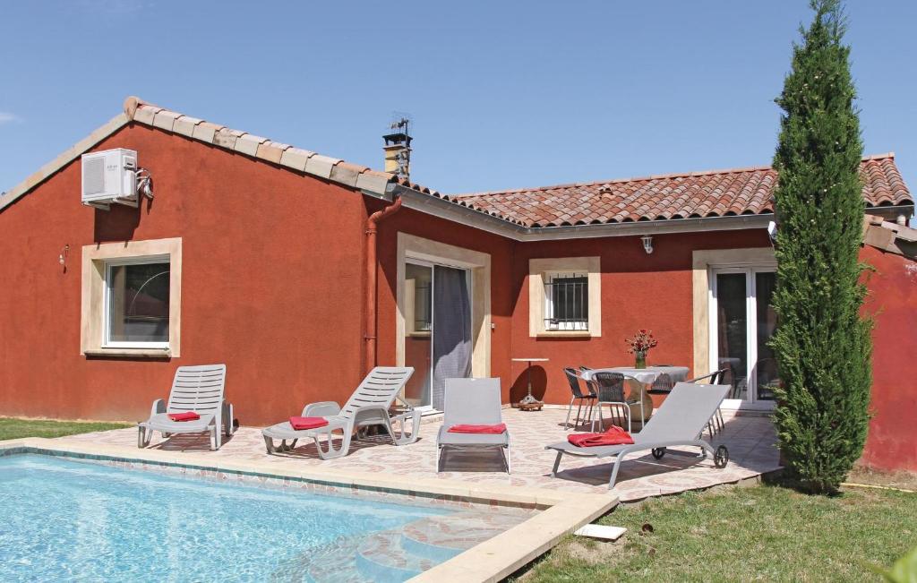 a house with a pool and chairs and a table at Nice Home In Ancone With 3 Bedrooms, Private Swimming Pool And Outdoor Swimming Pool in Ancône