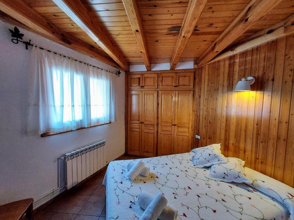 1 dormitorio con cama y techo de madera en Camping Solau en Espot
