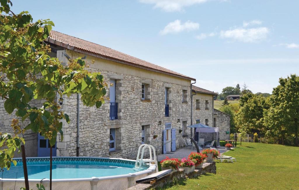 an old stone building with a swimming pool in front of it at Pet Friendly Home In Belvèze With Wifi in Valprionde