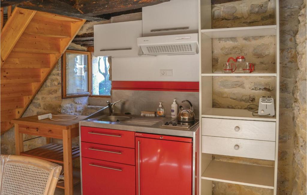 a kitchen with a red refrigerator and a sink at Lovely Home In Padirac With Wifi in Padirac