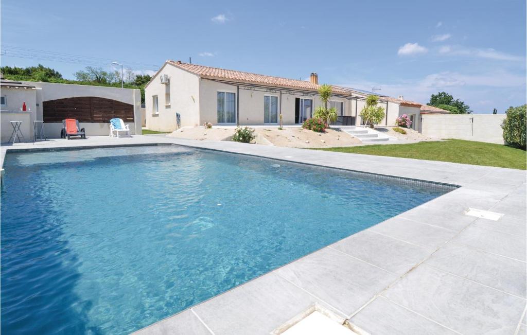 a swimming pool in front of a house at Stunning Home In Sernhac With Swimming Pool in Sernhac