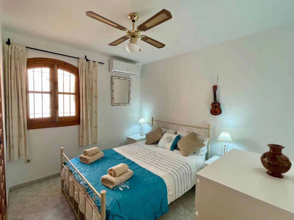a bedroom with a bed and a ceiling fan at Apartment with Panoramic Views, San Juan de Capistrano, Nerja in Nerja