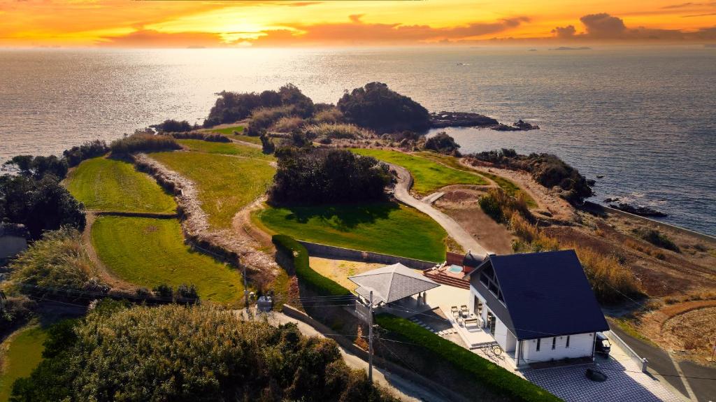 an aerial view of a house on an island in the ocean at ritomaru villa @ hatsuyama iki in Iki