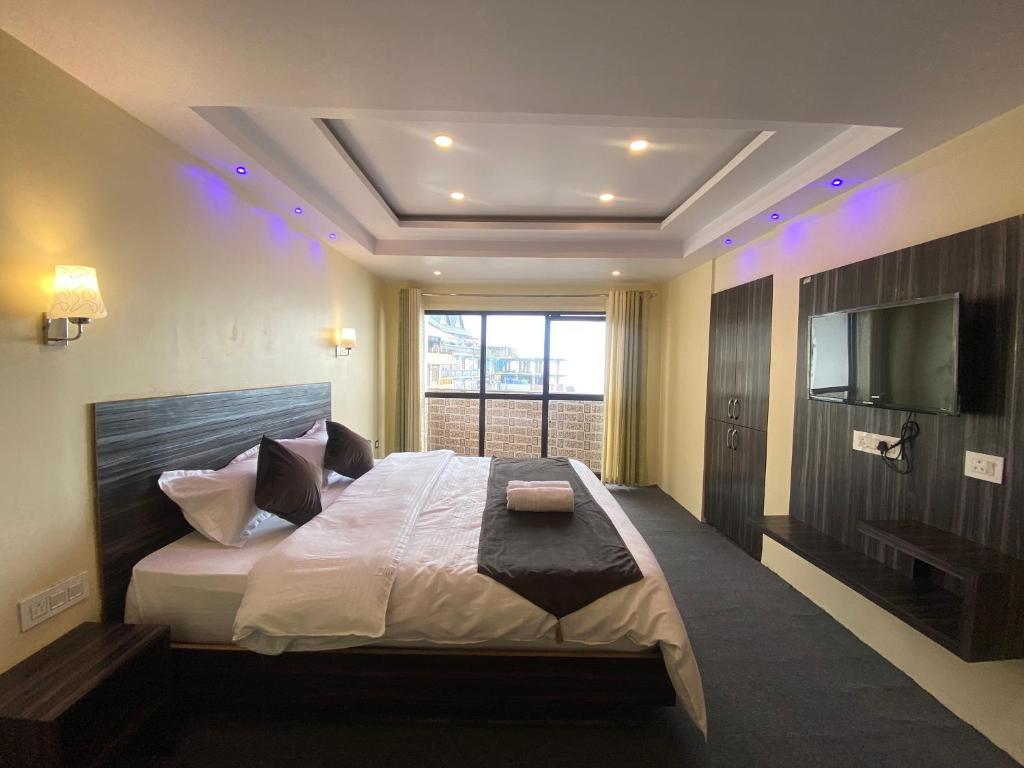 Ένα ή περισσότερα κρεβάτια σε δωμάτιο στο Hotel Amaira