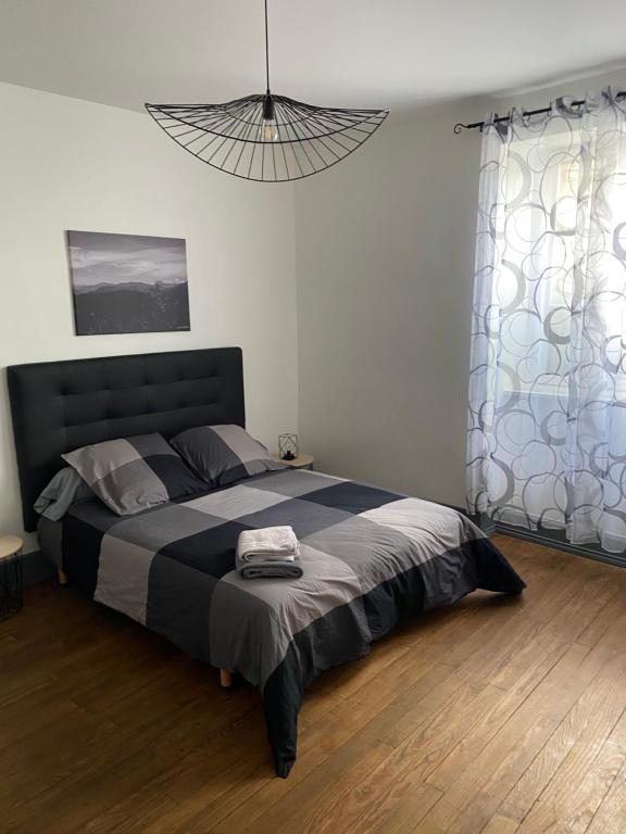 a bedroom with a large bed with a black headboard at Le 31 