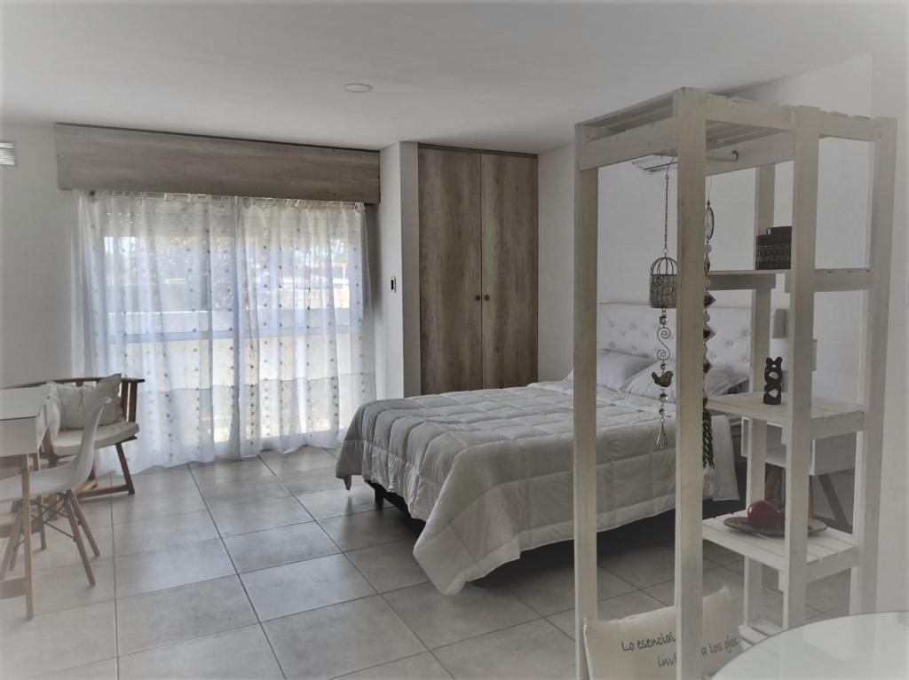 a bedroom with a bed and a table and a desk at Cabrera in Junín