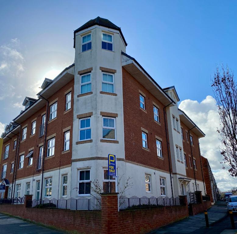 a large brick building on a city street at Luxurious Loft Flat 2-bed/2-bath in South Shields
