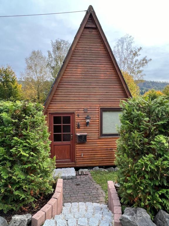 a wooden cabin with a gambrel roof at Haus Luzia in Meschede