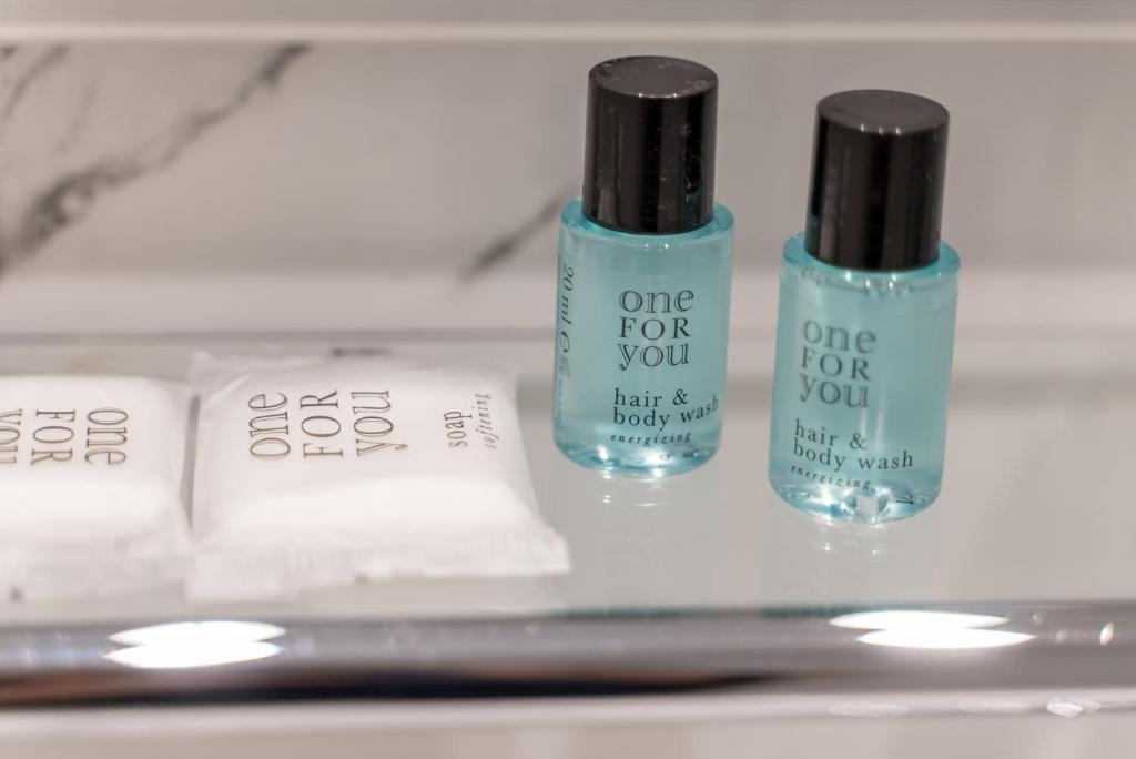 three bottles of nail polish sitting on a shelf at Hotel Miramar in Cap d'Ail