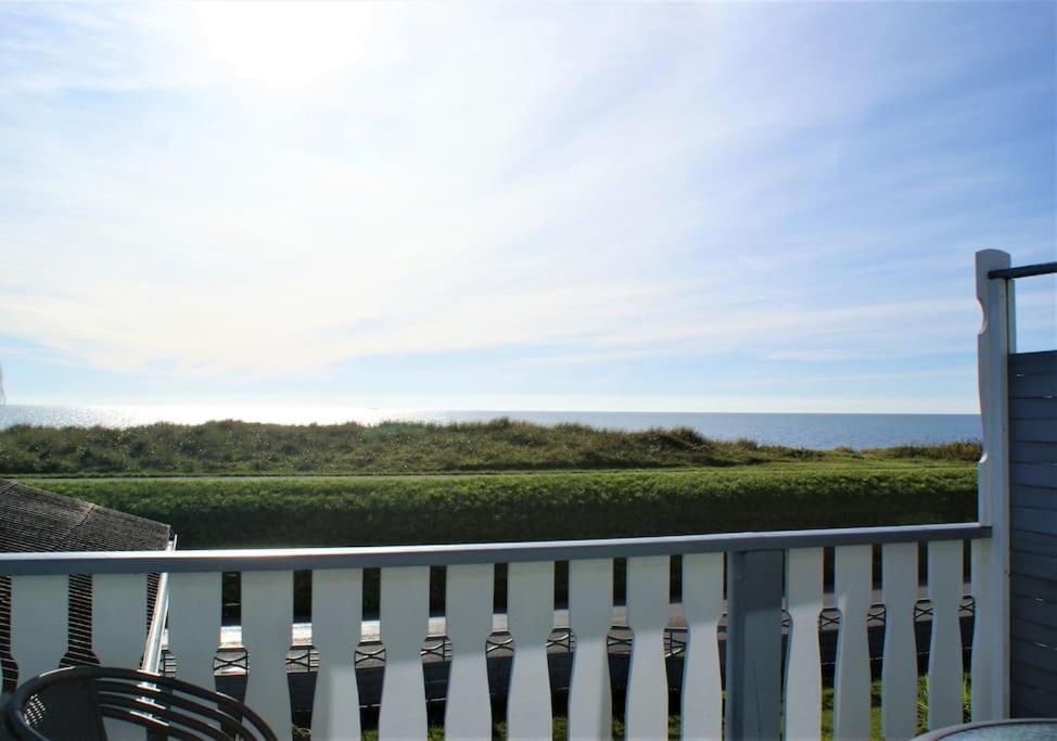 a balcony with a view of the ocean at Havudsigt Ferielejlighed in Dannemare