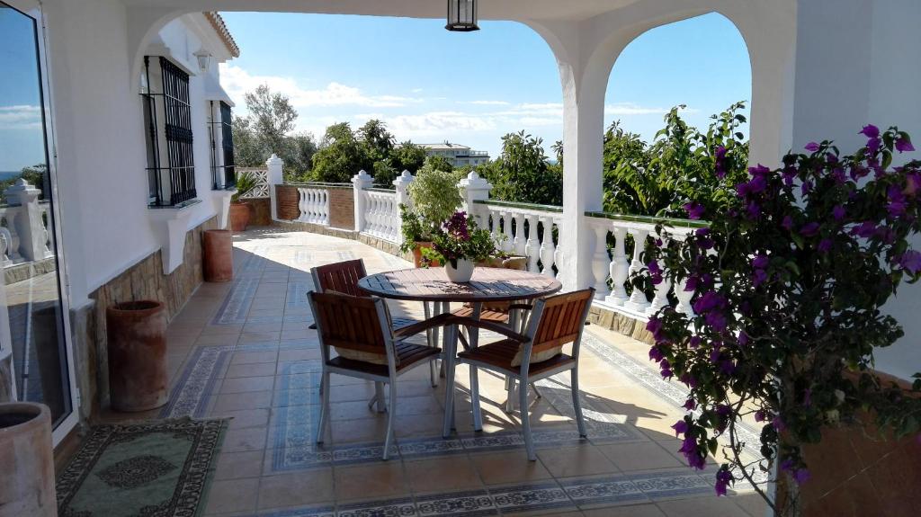 a patio with a table and chairs on a balcony at Casa Paloma Blanca in Málaga