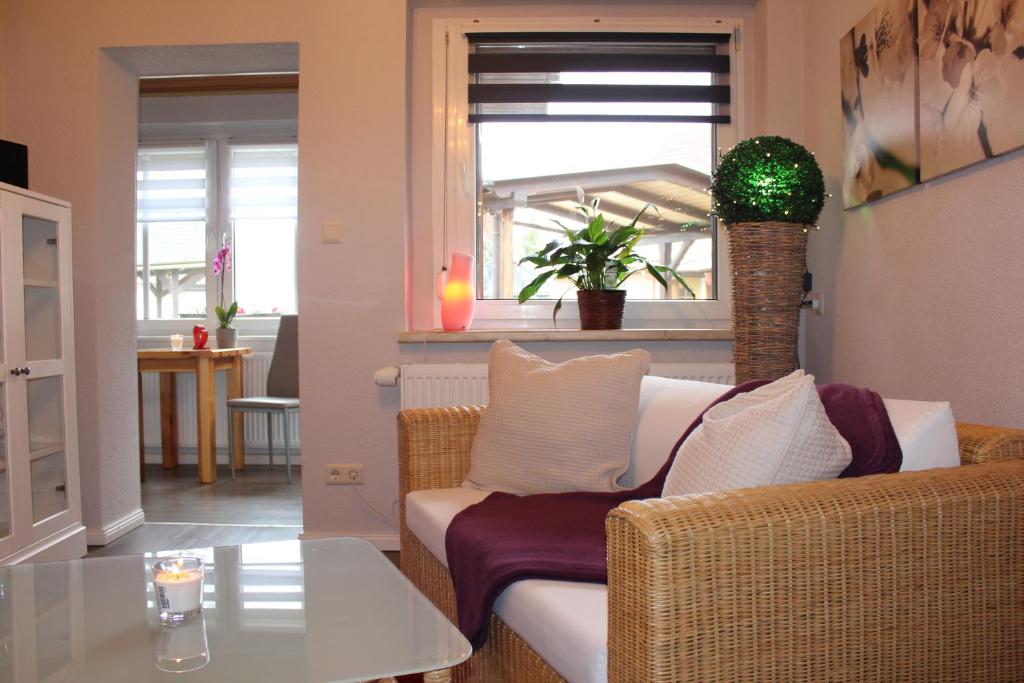 a living room with a white couch and a table at Spreewald Unterkünfte in Briesensee