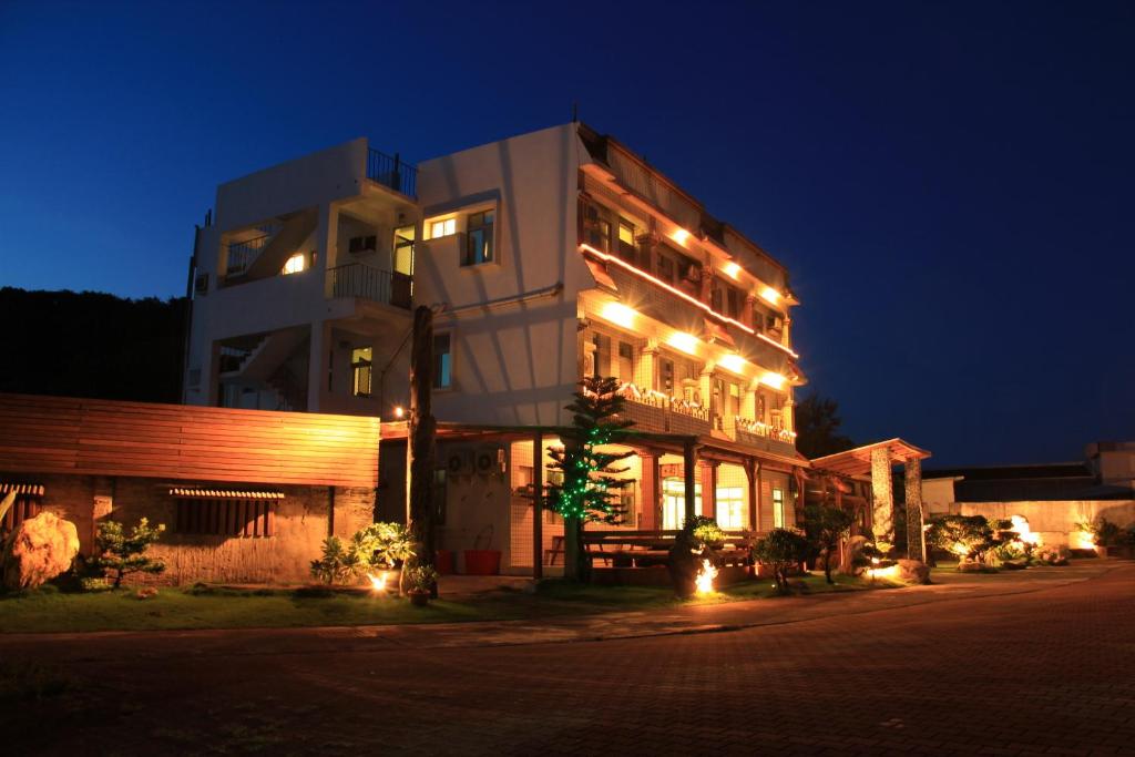 a large building with lights on it at night at Star-Moon B&B Green Island in Green Island