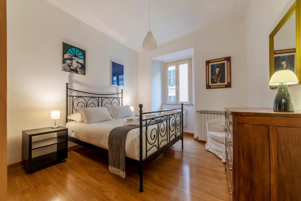 a bedroom with a bed and a dresser at Tucked away and quiet by Piazza Navona - FromHometoRome in Rome