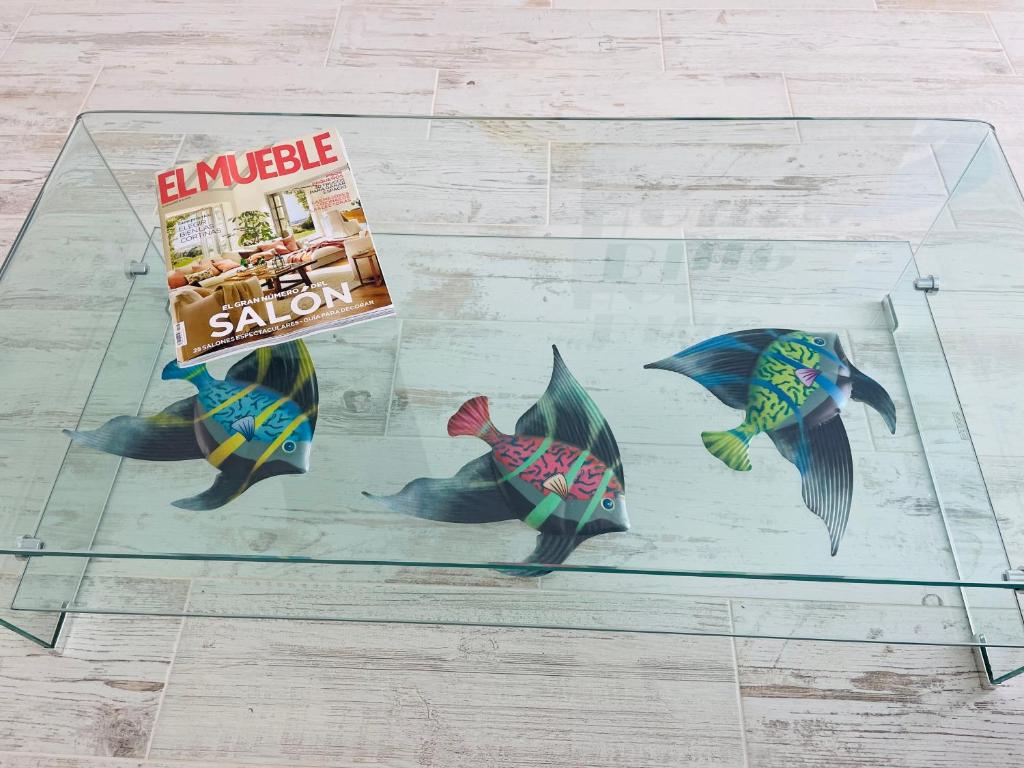 a display case with three fish and a package of sushi at Blue House Mallorca in Ses Salines