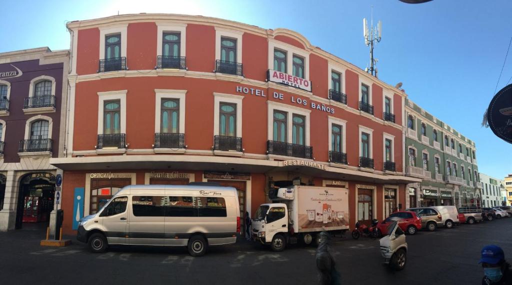 a building with a white van parked in front of it at Hotel de los baños in Pachuca de Soto