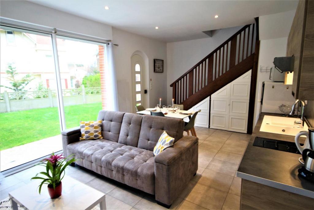 a living room with a couch and a table at Contre vents et marées in Mesnil-Val-Plage