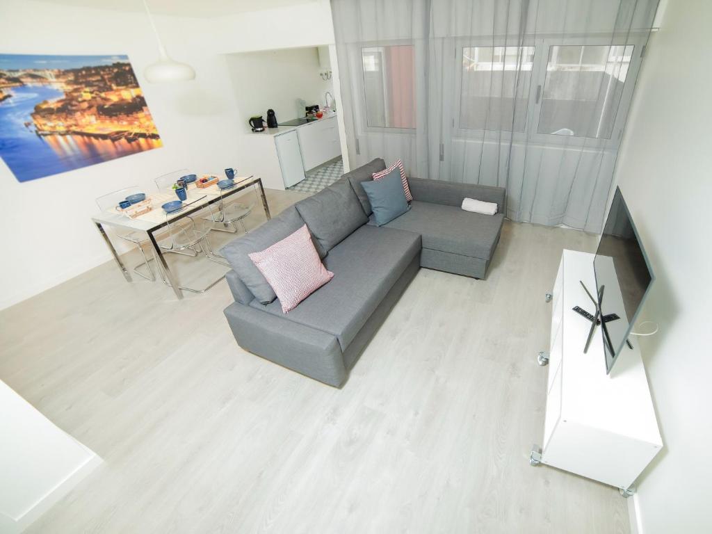 a living room with a couch and a table at CM Vintage Apartments in Porto