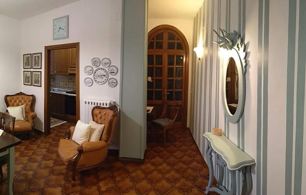 a living room with two chairs and a table at Casa di nonna Cate in Montepulciano