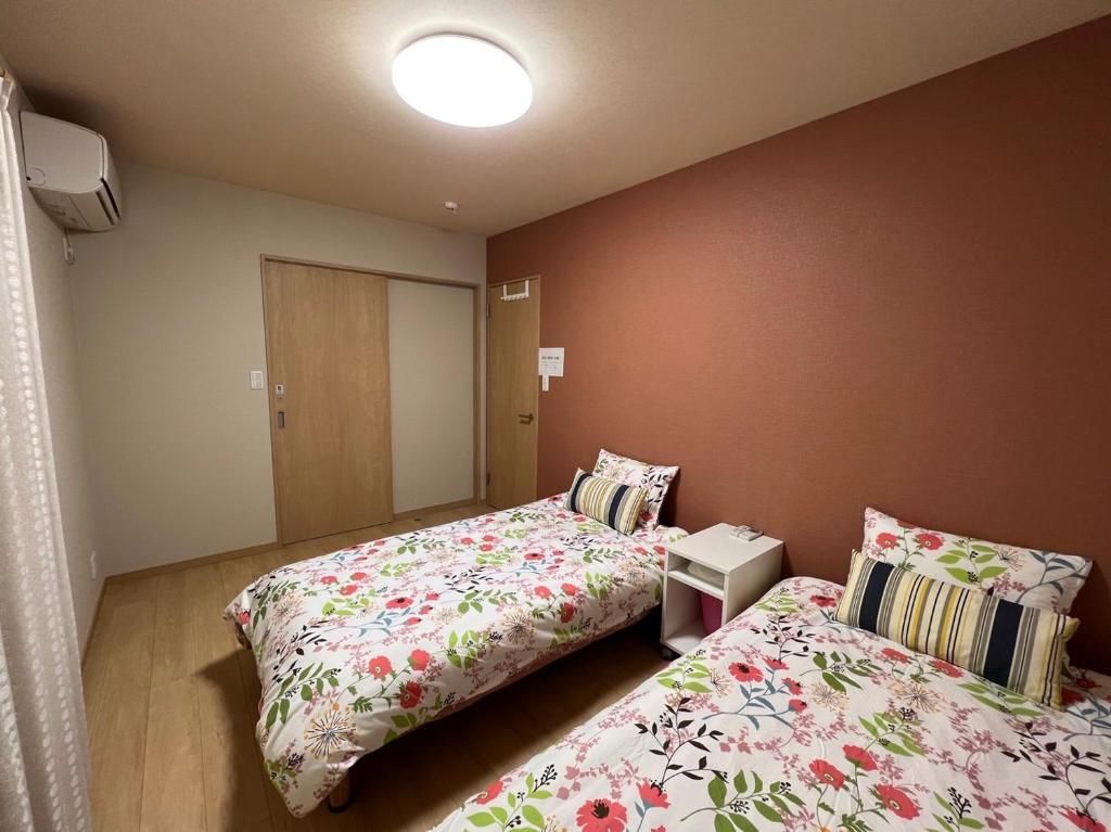 Postel nebo postele na pokoji v ubytování Guesthouse Kaede Annex