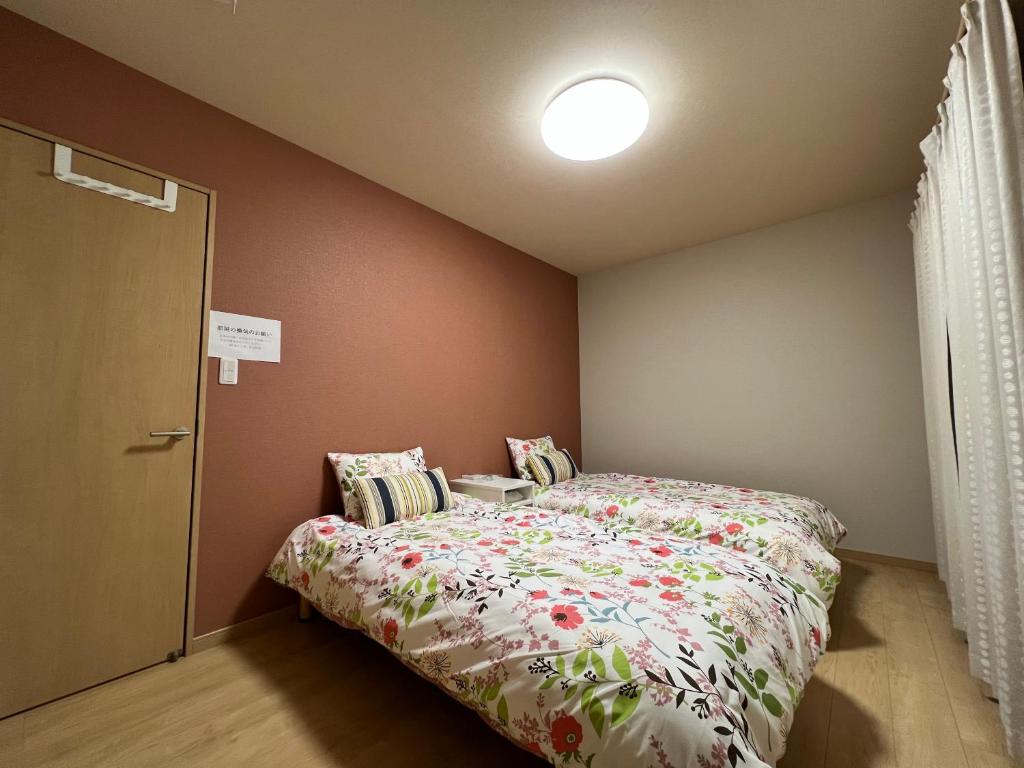 Postel nebo postele na pokoji v ubytování Guesthouse Kaede Annex