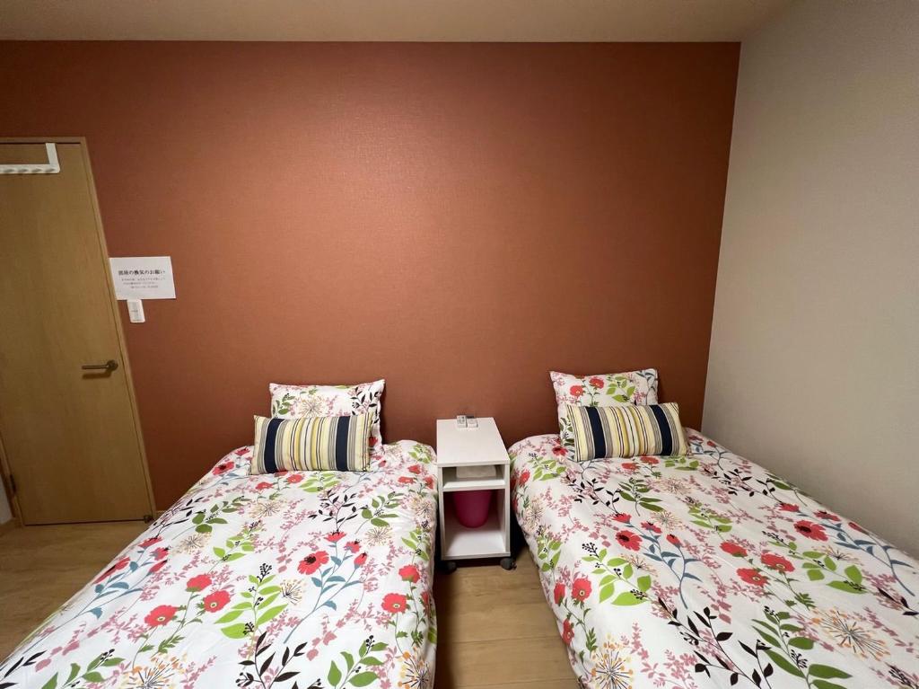 Postel nebo postele na pokoji v ubytování Guesthouse Kaede Annex
