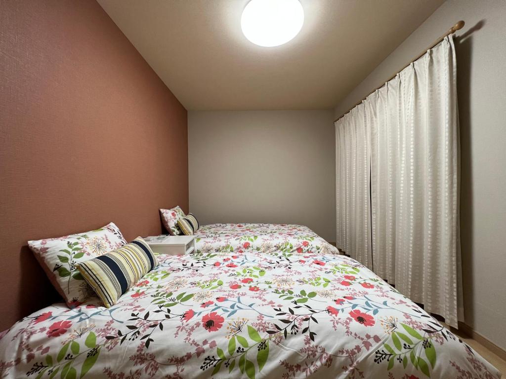 Postel nebo postele na pokoji v ubytování Guesthouse Kaede Annex