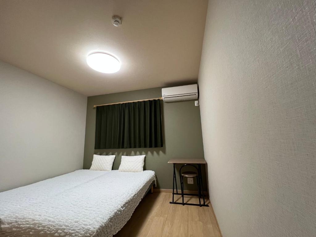 Postel nebo postele na pokoji v ubytování Guesthouse Kaede Annex