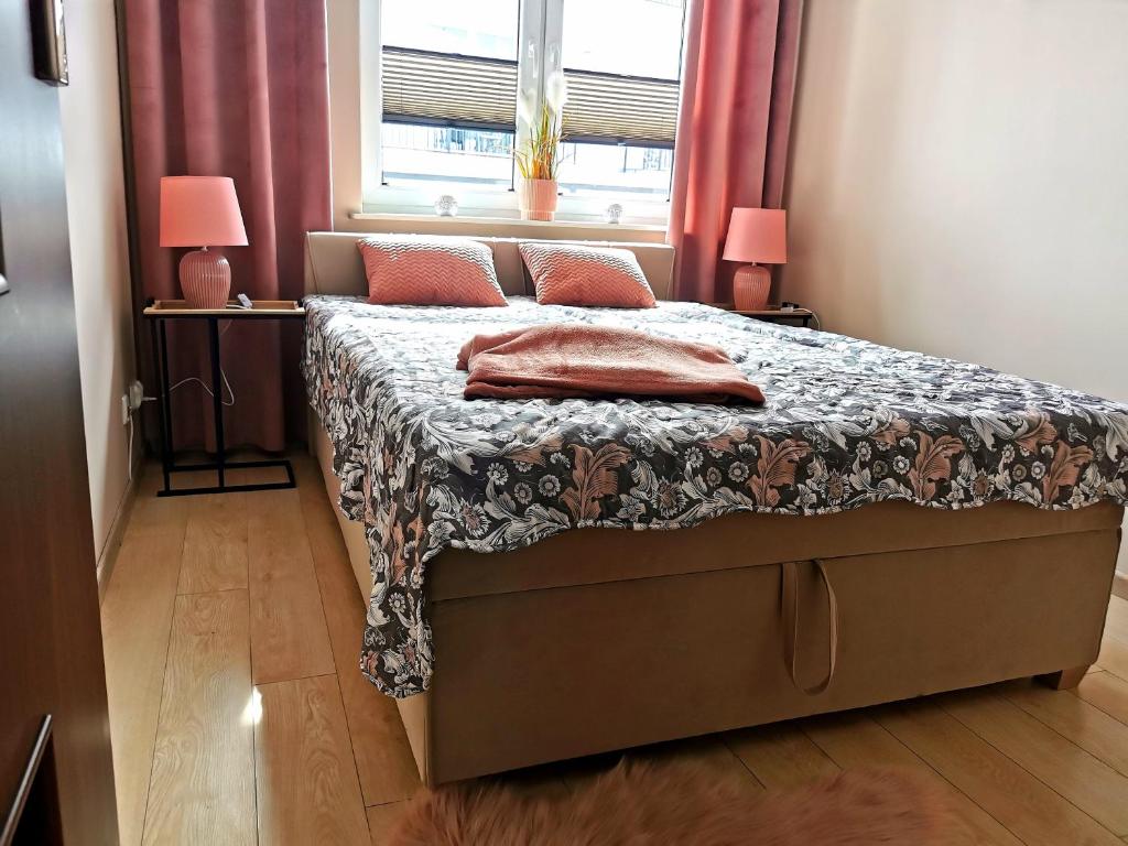 Posteľ alebo postele v izbe v ubytovaní Markowe Apartamenty Złoty Park