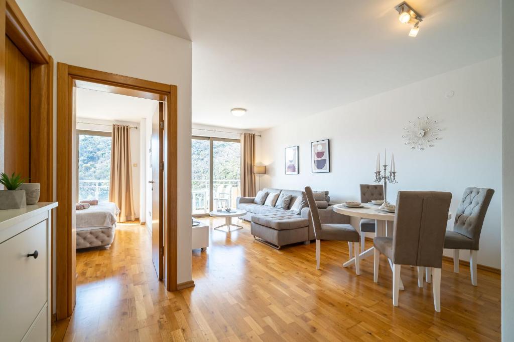 a living room with a couch and a table at Luxury apartment near beach in Pržno