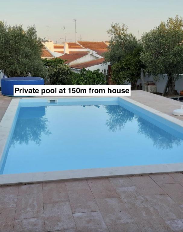 a blue pool at from house at Casinhas Alegria in São Marcos do Campo