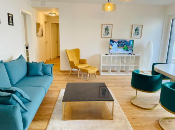 uma sala de estar com um sofá azul e cadeiras em Brand New Luxury 3 bedrooms, Terrace and Free Parking - noah em Luxemburgo
