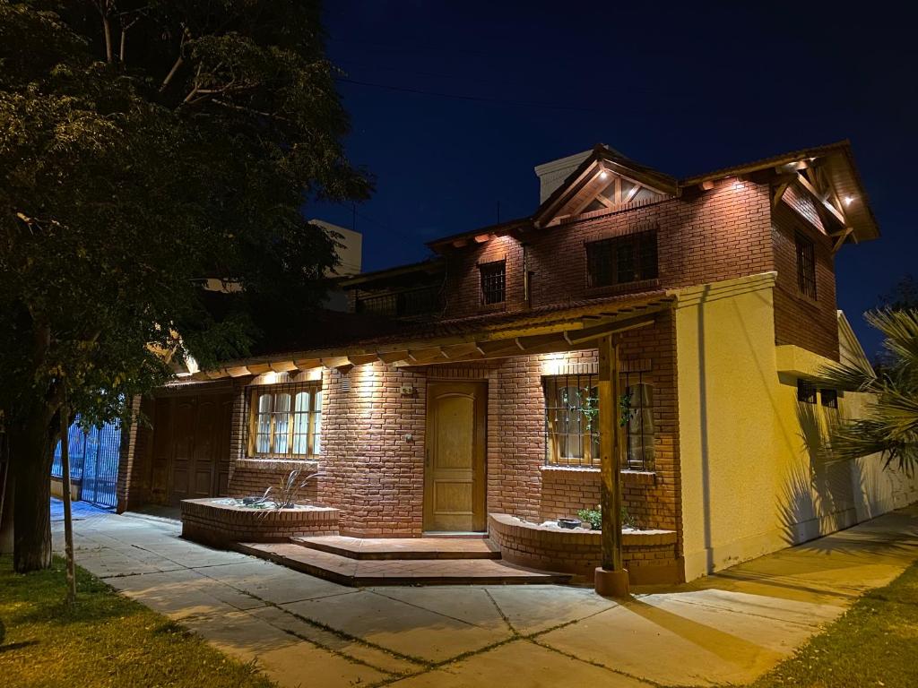 a brick house with lights on it at night at Amanecer de Oro in Guaymallen