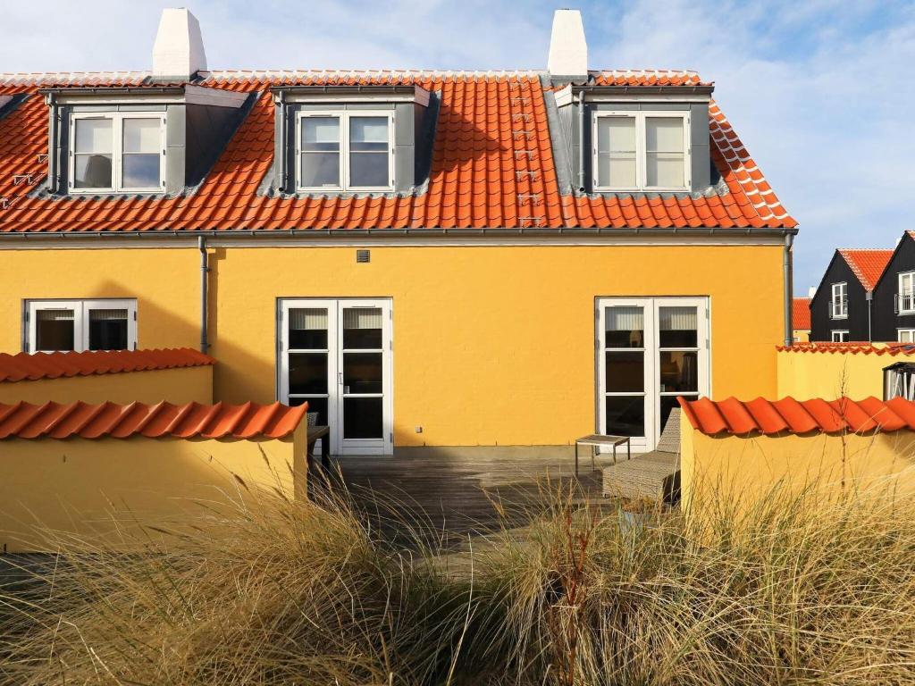 a yellow house with an orange roof at 6 person holiday home in Skagen-By Traum in Skagen