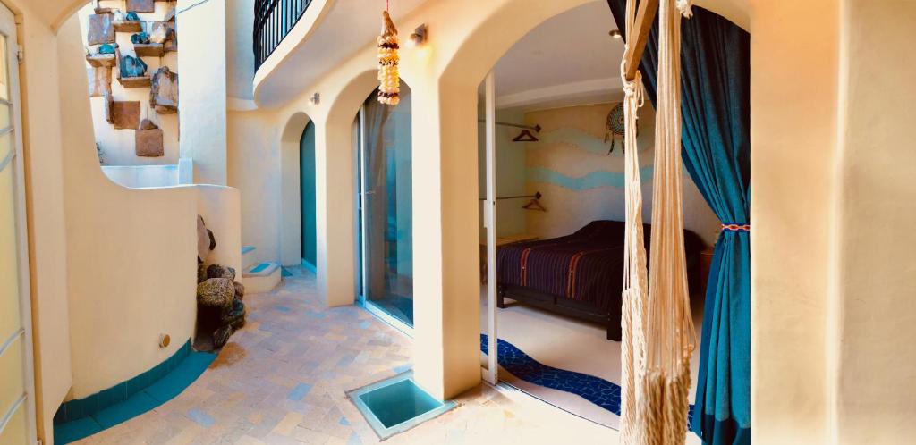 a bedroom with a bed in a room with a hallway at Magnolias Boutique Suites & SPA in San Cristóbal de Las Casas