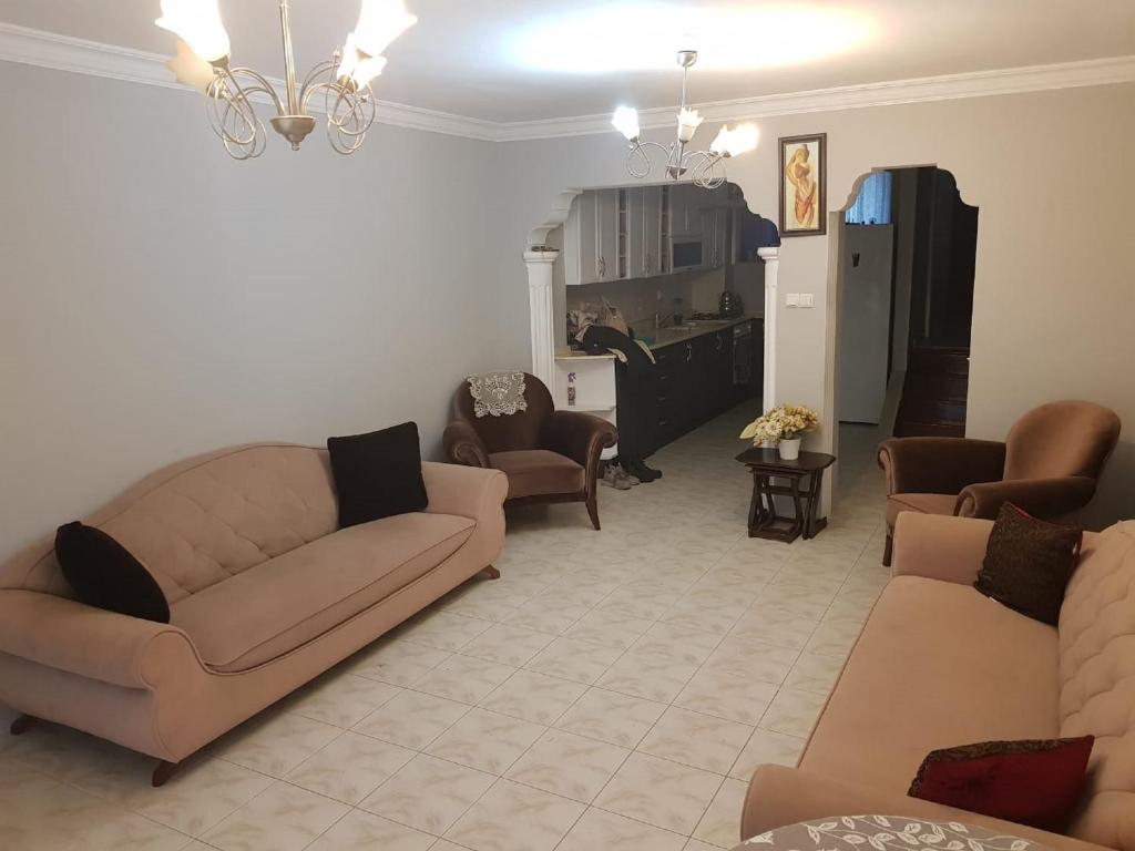 a living room with two couches and a kitchen at 2 munites walk to Ladies Beach in Aydın